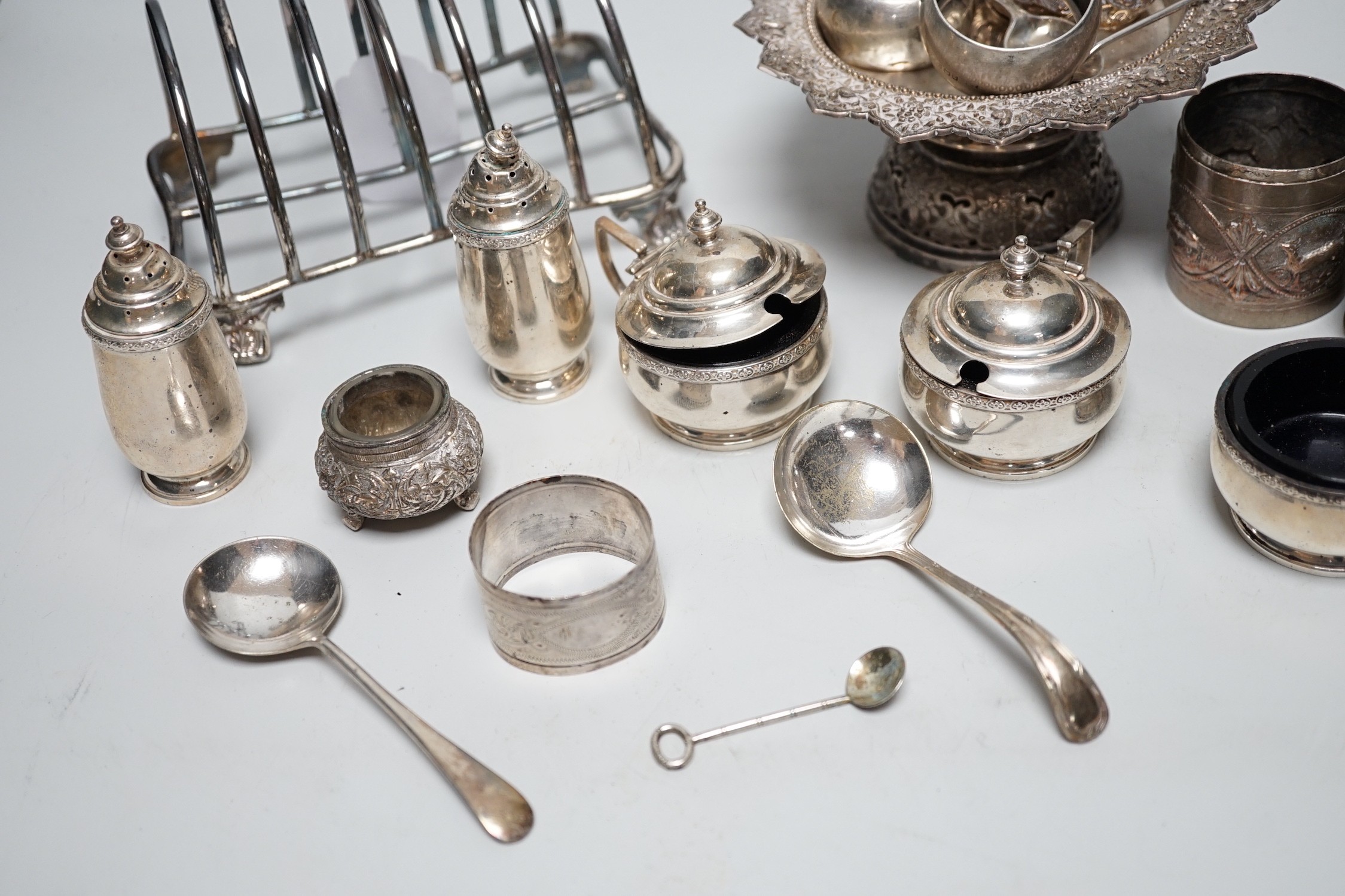 A George IV silver seven bar toast rack, by Robinson, Edkins & Aston, Birmingham, 1827, length 15.7cm, a George V silver six piece condiment set, Mappin & Webb, Birmingham, 1929, a silver coffee spoon and repousse box, t